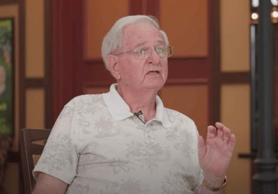 A senior man speaking in a well-lit interior