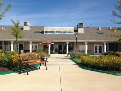 Exterior view of a senior living facility with garden area
