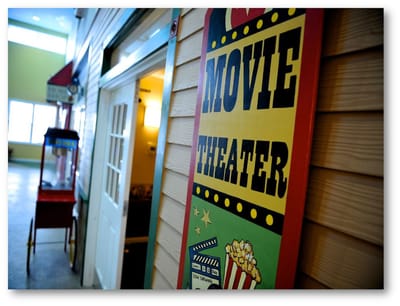 A colorful movie theater sign in a facility common area