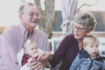 Residents enjoying time with young children in an outdoor space