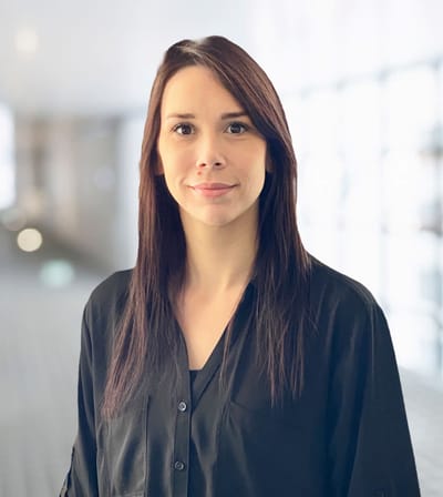 Woman smiling in a facility corridor