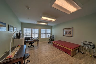 Interior view of a therapy room with exercise equipment