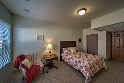 Comfortable resident room with a bed and seating area