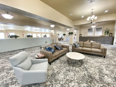 Common area with seating and decor in a senior living facility