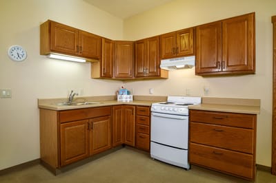 Kitchen area with wooden cabinets and stove