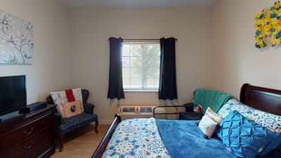 Cozy private room with bed and furniture