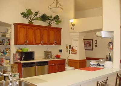Bright kitchen area with cabinets and counter space