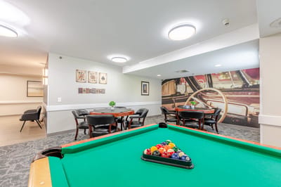 Interior view of a common area with pool table and seating