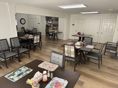 Dining room setup with tables and meal items visible