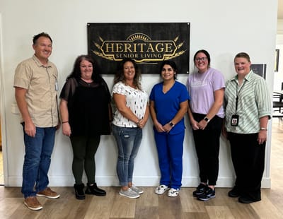 Staff members posing in the facility lobby