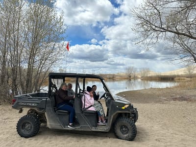 Residents enjoying an outdoor ride in an ATV