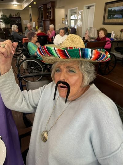 Resident participating in a fun activity with props