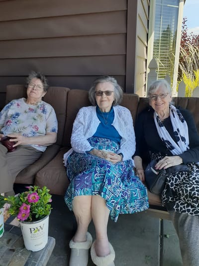 Three residents enjoying time together outside