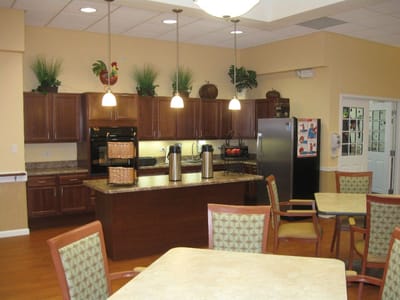 Bright common area with kitchen and tables