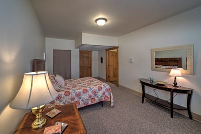 Cozy resident room with floral bedding and lamps