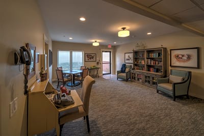 A cozy common area with bookshelves and seating
