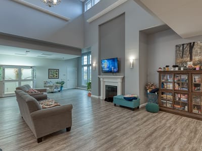 Bright common area with seating and TV.
