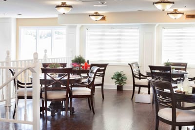 Bright dining area with wooden tables and chairs