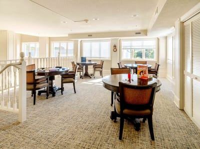 Bright activity room with tables and chairs for games
