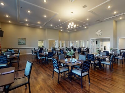 Bright dining room with tables set for meals