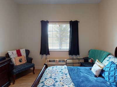 Cozy resident bedroom with window and furnishings