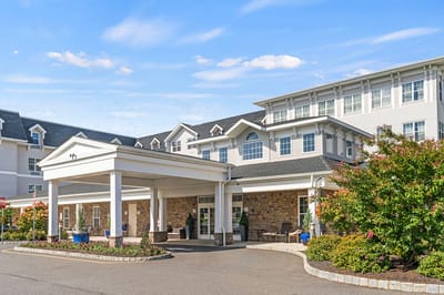 Front entrance of a senior living facility with landscaping