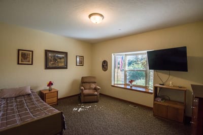 Cozy resident room with bed and seating area