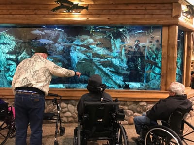 Residents enjoying the aquarium view in a common area