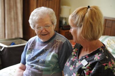 A caregiver talking with a resident in a private room