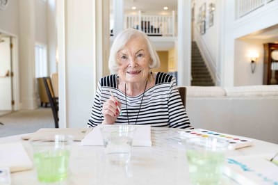 Resident engaged in a painting activity in a common area