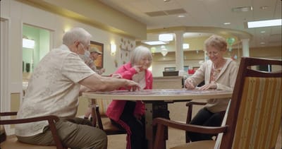 Residents engaged in an activity at a round table