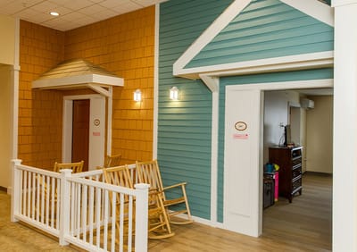 Brightly colored interior with rocking chairs and bunting