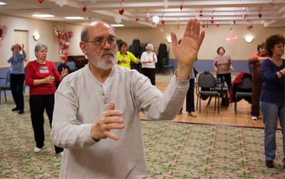 Residents participating in an indoor group exercise class