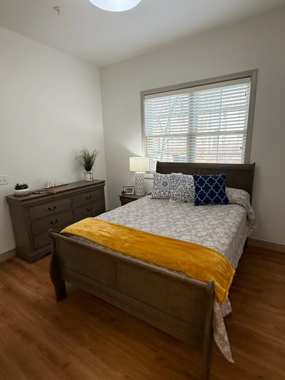 Cozy resident bedroom with wooden furniture and decor