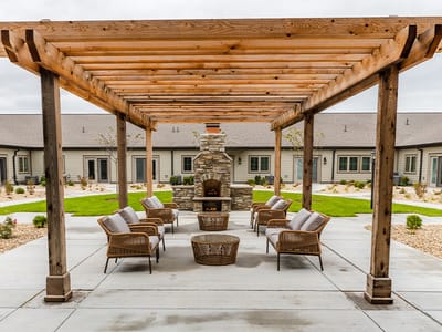 Outdoor seating area with a fireplace and garden view