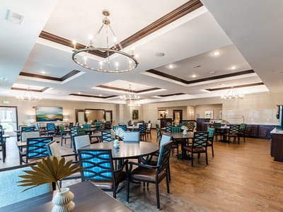 Bright dining area with tables and chairs set up