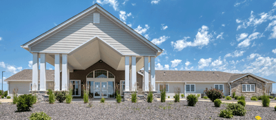 Exterior view of Cedarhurst facility with landscaped entrance