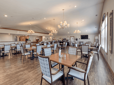 Dining room with tables and chairs, well-lit