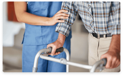 Staff assisting a resident with a walker