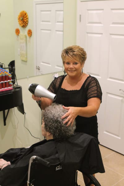 Sunshine Gardens, assisted living in Marion, IL — Hair stylist drying resident's hair in a salon setting