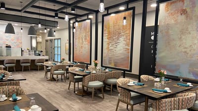 Modern dining room with elegant decor and tables set