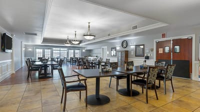 Dining room with tables and chairs in a bright setting