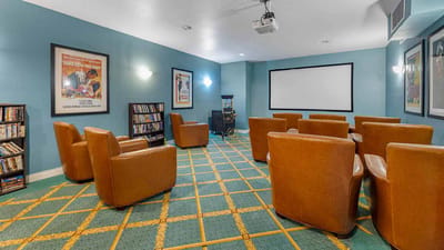 Interior common area with seating and a movie screen