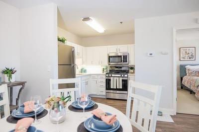 Bright kitchen area with dining table set for a meal
