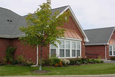 Exterior view of a senior living facility with landscaped gardens