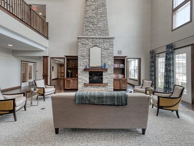 Bright common area with seating and a fireplace