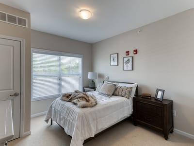 Cozy private resident room with a bed and furniture