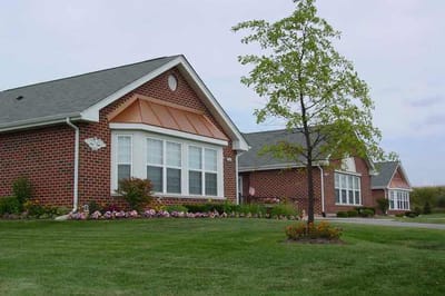 Exterior view of a senior living building with landscaping