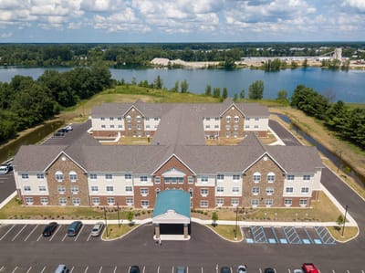 Aerial view of Hellenic Senior Living facility by a lake