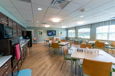 Dining area in a senior living facility with tables and chairs